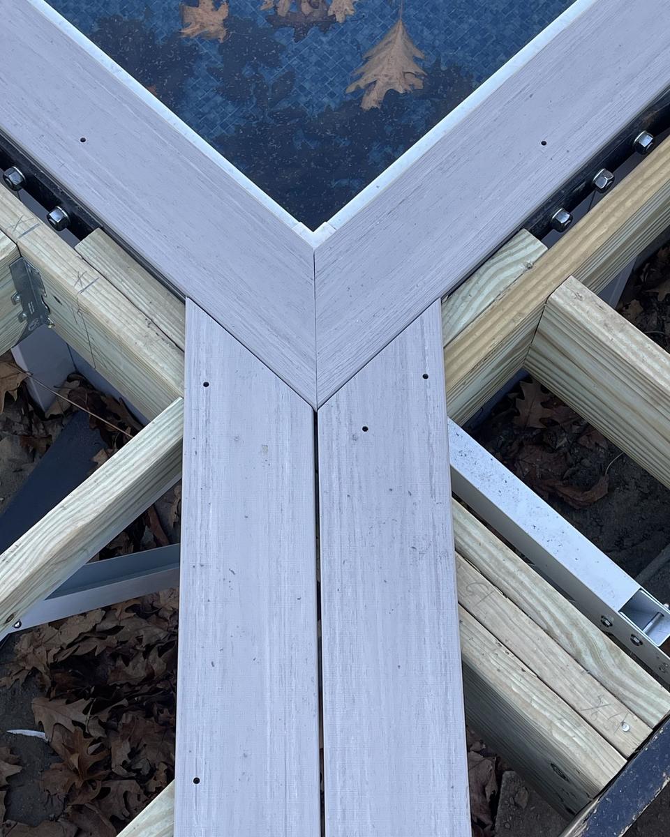 Tight mitered corner on a composite deck border by Masterline Carpentry