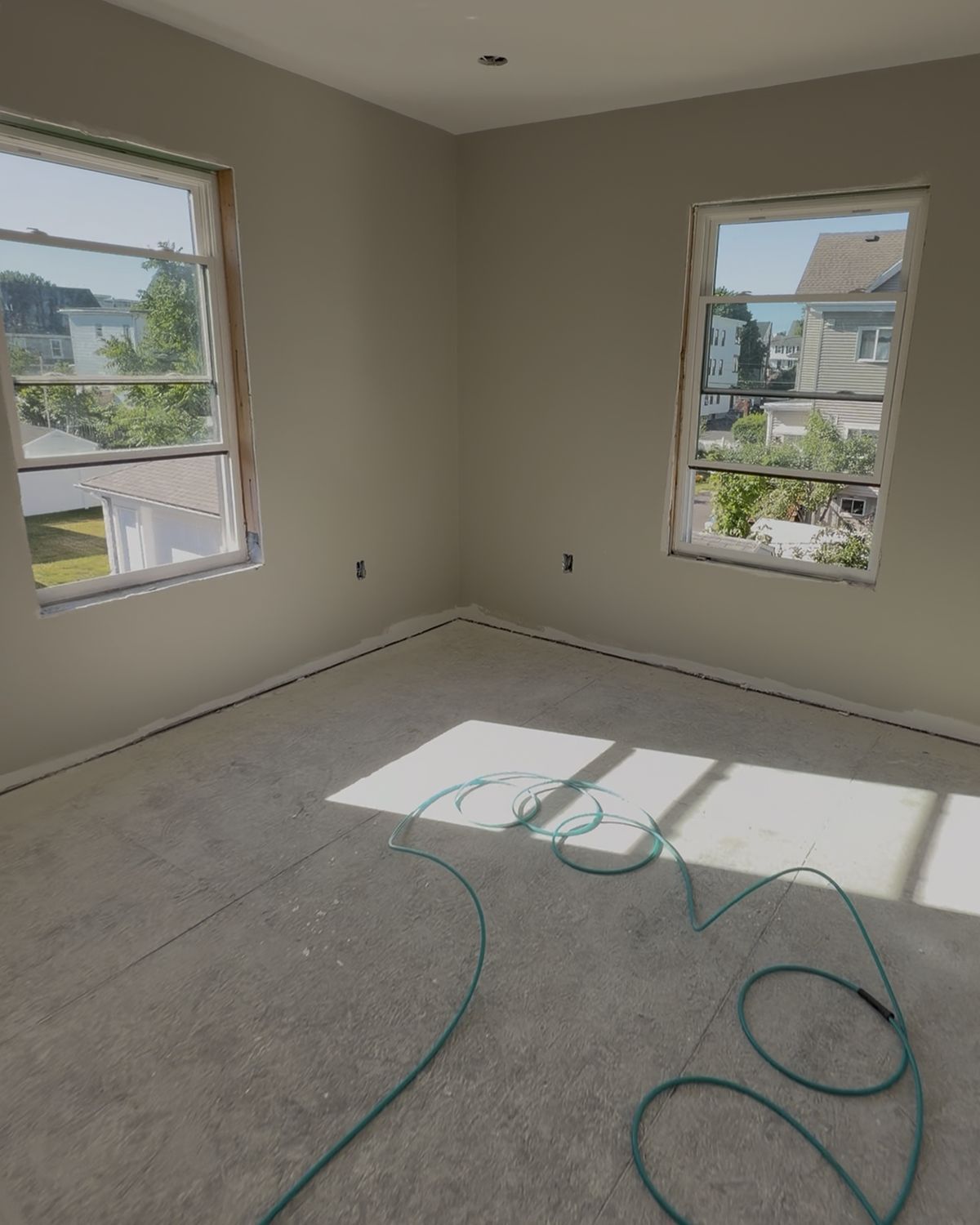 Bedroom before trim: window openings without casing, no baseboard